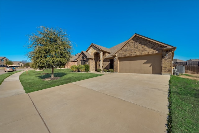 view of front of home featuring cooling unit, a front lawn, and a garage