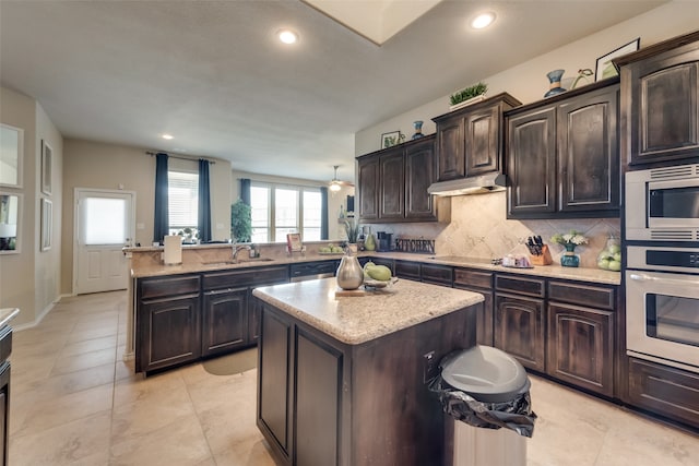 kitchen featuring dark brown cabinets, appliances with stainless steel finishes, and kitchen peninsula