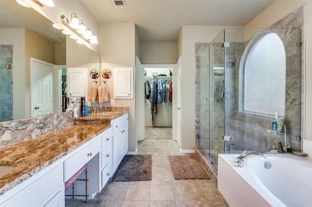 bathroom featuring vanity and separate shower and tub