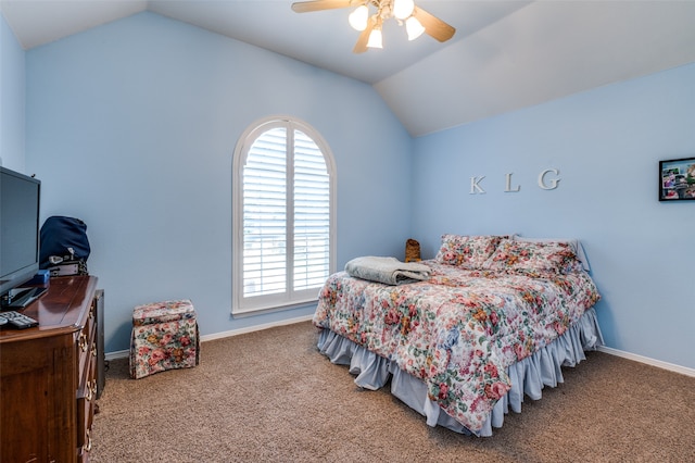 bedroom with ceiling fan, vaulted ceiling, and carpet floors