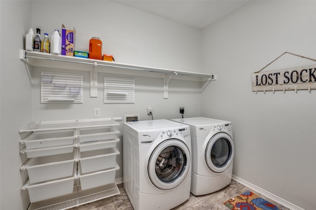 clothes washing area featuring washing machine and clothes dryer