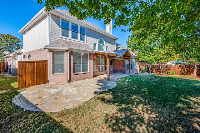 back of house featuring a yard, a patio area, and central AC unit