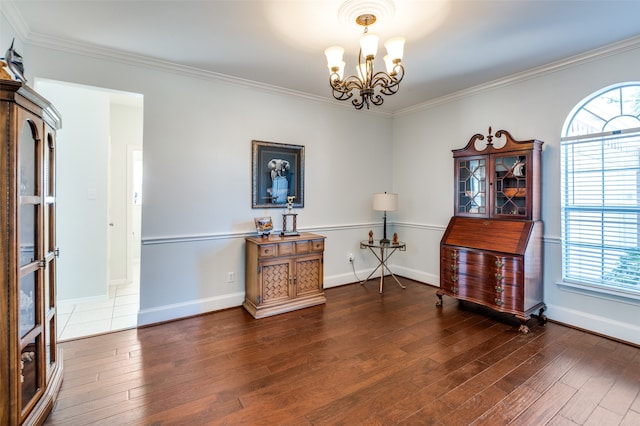 misc room with dark wood-type flooring, a notable chandelier, and crown molding