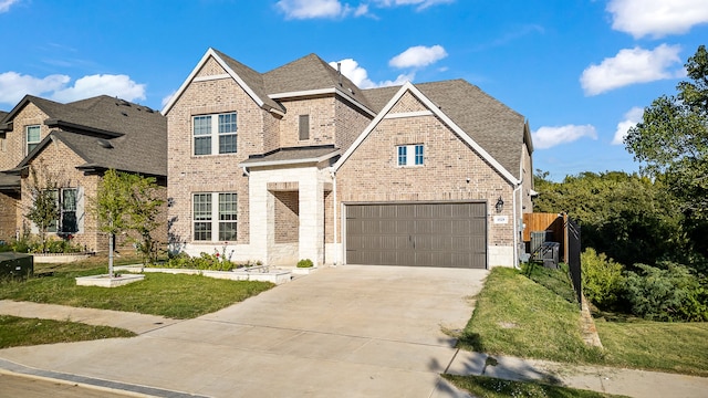 view of front of house with a front yard and a garage