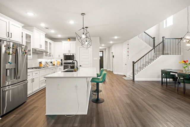 kitchen featuring appliances with stainless steel finishes, white cabinetry, and dark hardwood / wood-style flooring