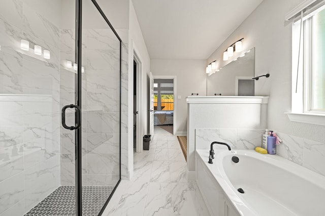 bathroom featuring separate shower and tub