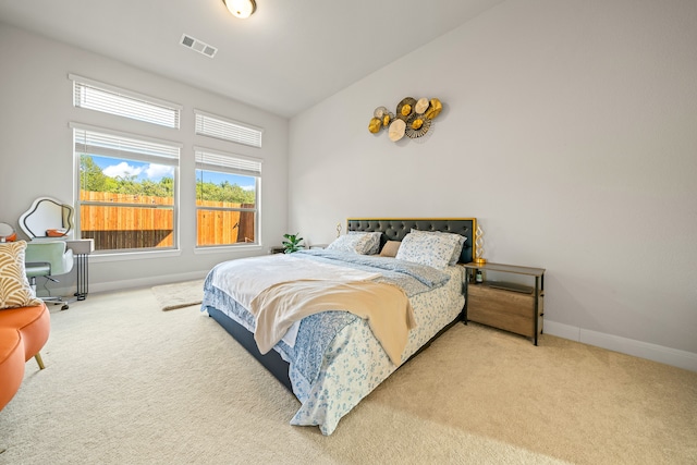 carpeted bedroom featuring vaulted ceiling