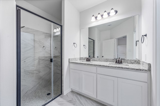 bathroom with vanity and a shower with door