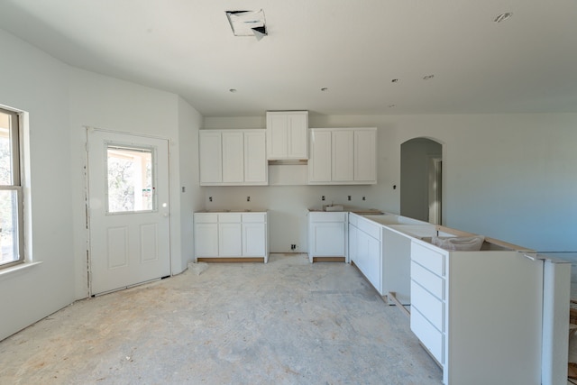 kitchen with white cabinetry and a wealth of natural light