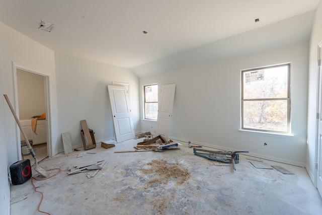 unfurnished bedroom featuring lofted ceiling