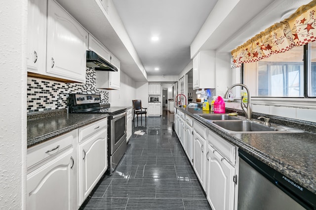 kitchen with dark tile patterned floors, exhaust hood, stainless steel appliances, sink, and white cabinets