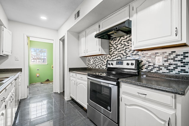 kitchen featuring tasteful backsplash, electric stove, dark tile patterned floors, white cabinets, and custom range hood