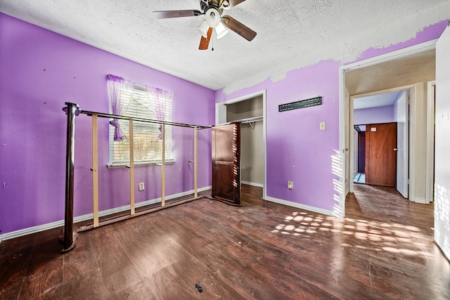 unfurnished bedroom featuring a closet, a textured ceiling, wood-type flooring, and ceiling fan