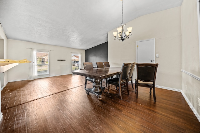 dining room featuring a textured ceiling, vaulted ceiling, dark hardwood / wood-style floors, and an inviting chandelier