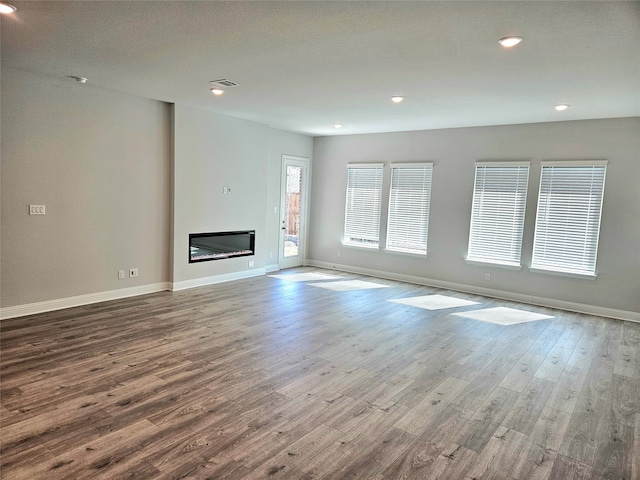 unfurnished living room featuring hardwood / wood-style flooring