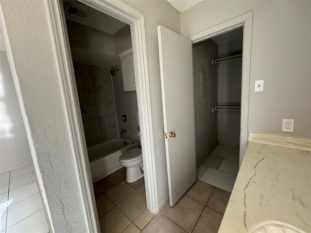 full bathroom with vanity, toilet, tile patterned flooring, and tiled shower / bath