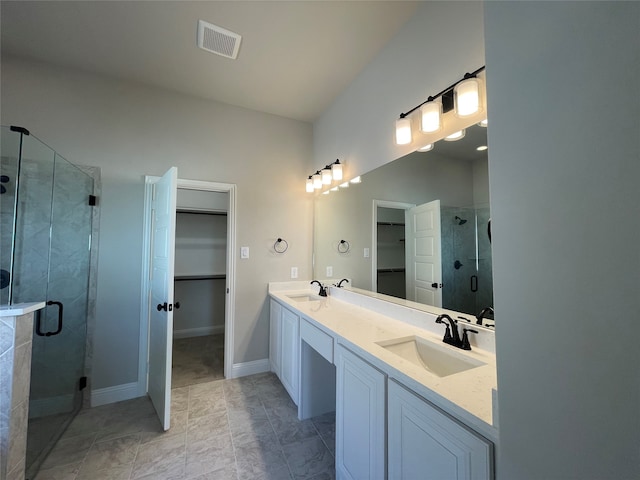 bathroom featuring vanity and a shower with shower door