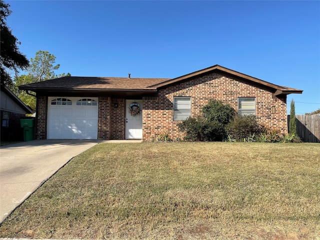 single story home featuring a front lawn and a garage