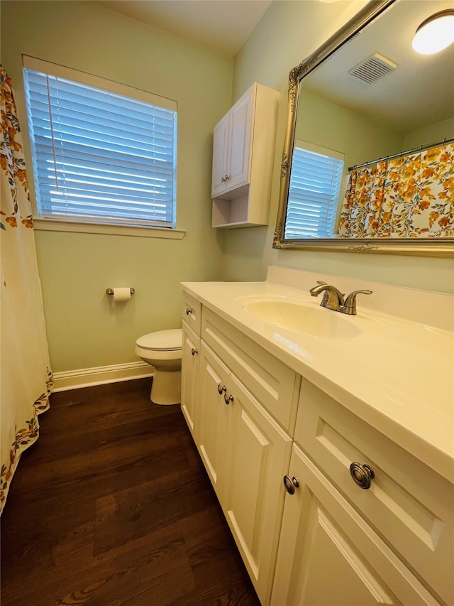 bathroom featuring vanity, hardwood / wood-style flooring, and toilet