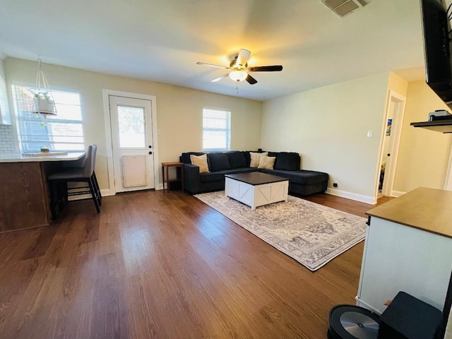 living room with dark hardwood / wood-style floors and ceiling fan