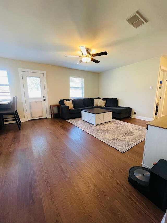 living room with hardwood / wood-style flooring, ceiling fan, and a wealth of natural light