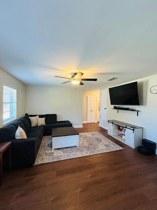 living room featuring wood-type flooring and ceiling fan