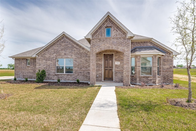 2420 Cross Timbers Dr, Lowry Crossing, TX 75069 - french country home with brick siding, a front yard, and a shingled roof