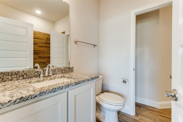 2420 Cross Timbers Dr, Lowry Crossing, TX 75069 - bathroom featuring toilet, vanity, wood finished floors, and baseboards