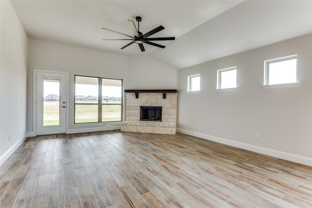 unfurnished living room with light wood-type flooring, lofted ceiling, and plenty of natural light