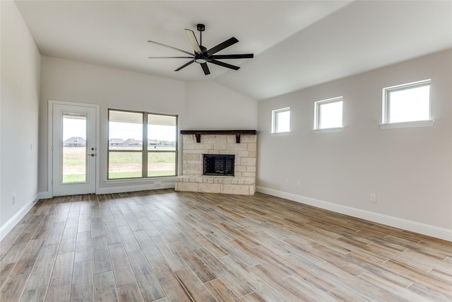 2420 Cross Timbers Dr, Lowry Crossing, TX 75069 - unfurnished living room with a ceiling fan, light wood finished floors, vaulted ceiling, baseboards, and a stone fireplace