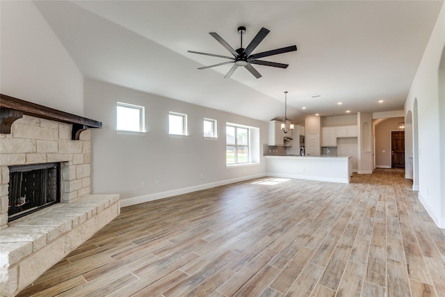 2420 Cross Timbers Dr, Lowry Crossing, TX 75069 - unfurnished living room with light wood-style flooring, a fireplace, ceiling fan, baseboards, and plenty of natural light