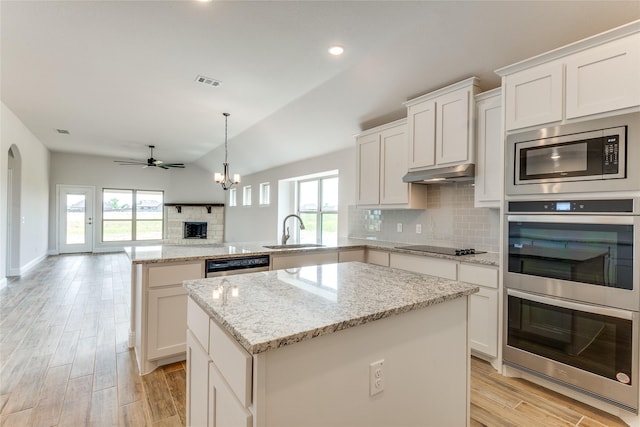 2420 Cross Timbers Dr, Lowry Crossing, TX 75069 - kitchen with a sink, stainless steel appliances, a peninsula, a kitchen island, and tasteful backsplash