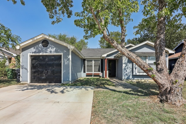 ranch-style house featuring a front lawn and a garage