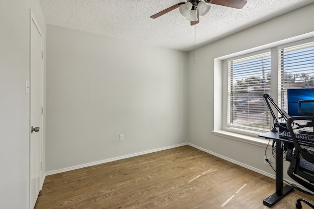 home office featuring a textured ceiling, hardwood / wood-style flooring, and ceiling fan