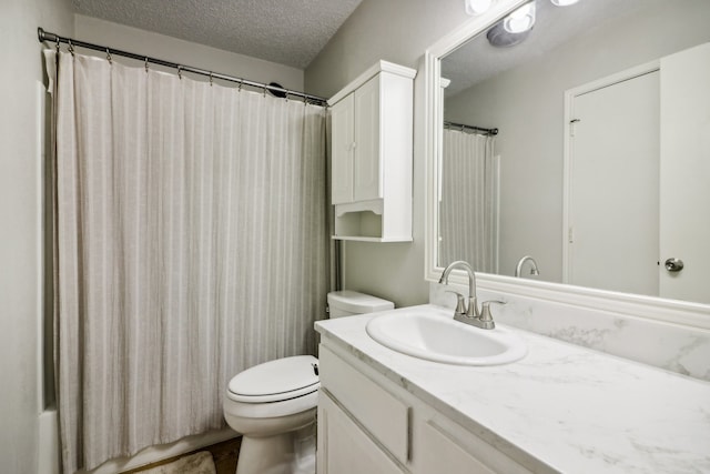 bathroom with toilet, a textured ceiling, a shower with curtain, and vanity