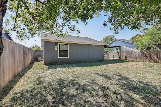 rear view of house featuring a yard