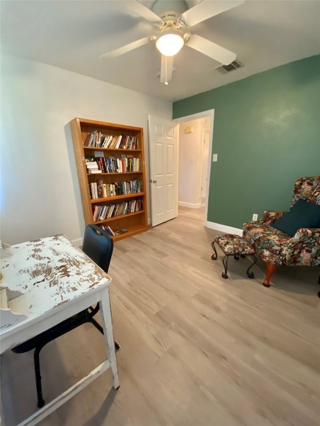 office space with light hardwood / wood-style floors and ceiling fan