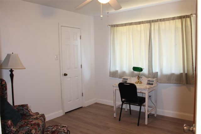 office with dark wood-type flooring and ceiling fan