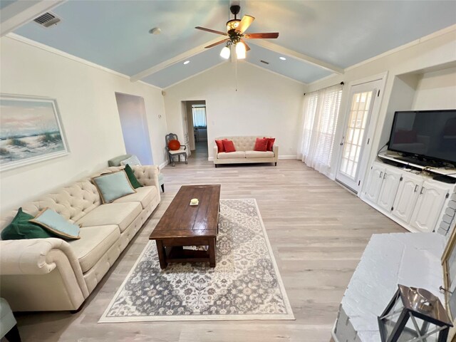 living room featuring ceiling fan, light wood-type flooring, a brick fireplace, ornamental molding, and lofted ceiling with beams