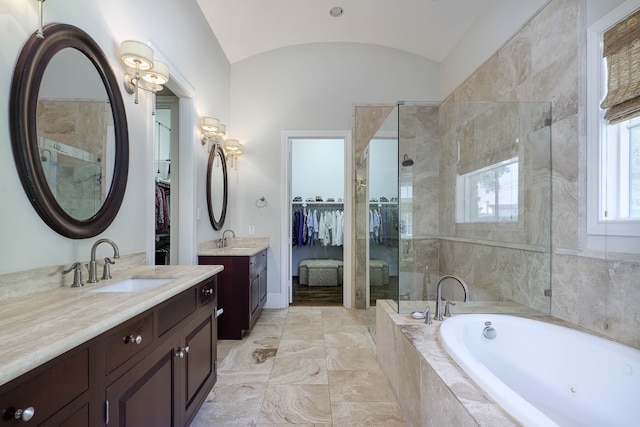 bathroom with vanity, separate shower and tub, and vaulted ceiling