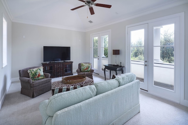 carpeted living room with french doors, ceiling fan, and crown molding