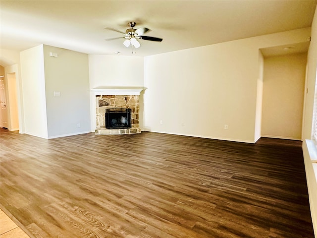 unfurnished living room featuring a fireplace, hardwood / wood-style flooring, and ceiling fan