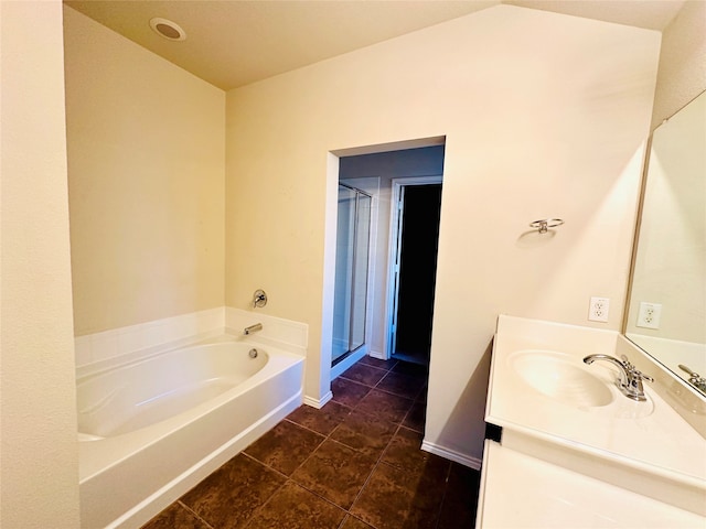 bathroom featuring vanity, plus walk in shower, and tile patterned flooring