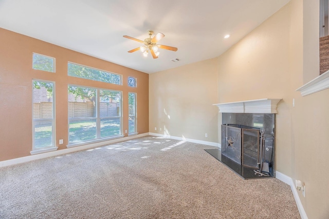 unfurnished living room with ceiling fan, carpet, lofted ceiling, and a fireplace