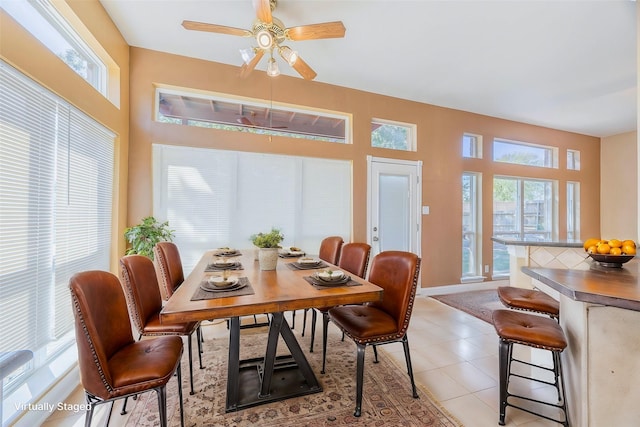 dining room with a wealth of natural light, ceiling fan, and light tile patterned floors