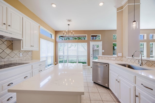 kitchen featuring backsplash, stainless steel dishwasher, under cabinet range hood, and a sink