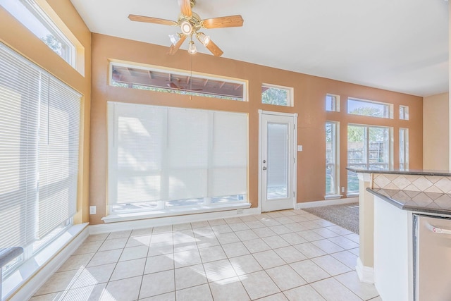 interior space featuring ceiling fan and plenty of natural light