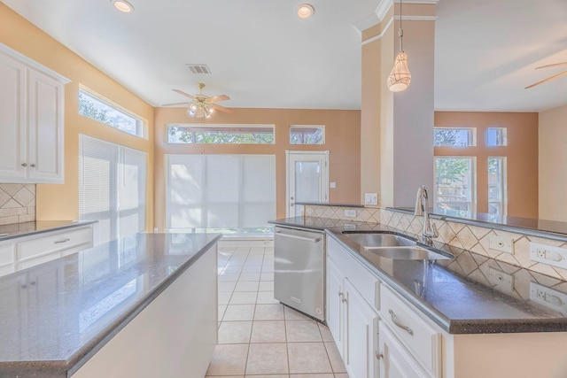 kitchen with sink, light tile patterned floors, dishwasher, ceiling fan, and white cabinets