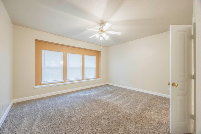 carpeted spare room with ceiling fan