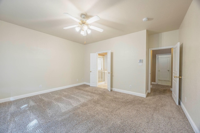 unfurnished bedroom with connected bathroom, light colored carpet, and ceiling fan